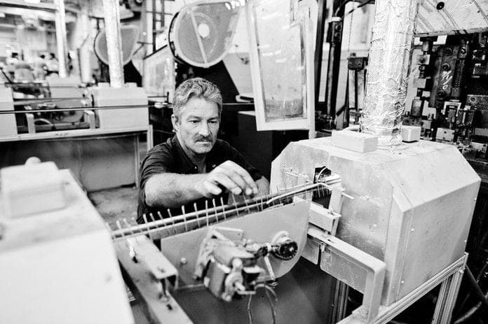 Experienced worker at industrial machine